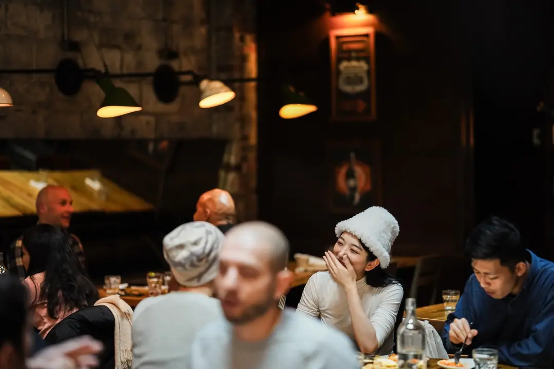 Diners laughing over dinner at Gusto 101 in the evening