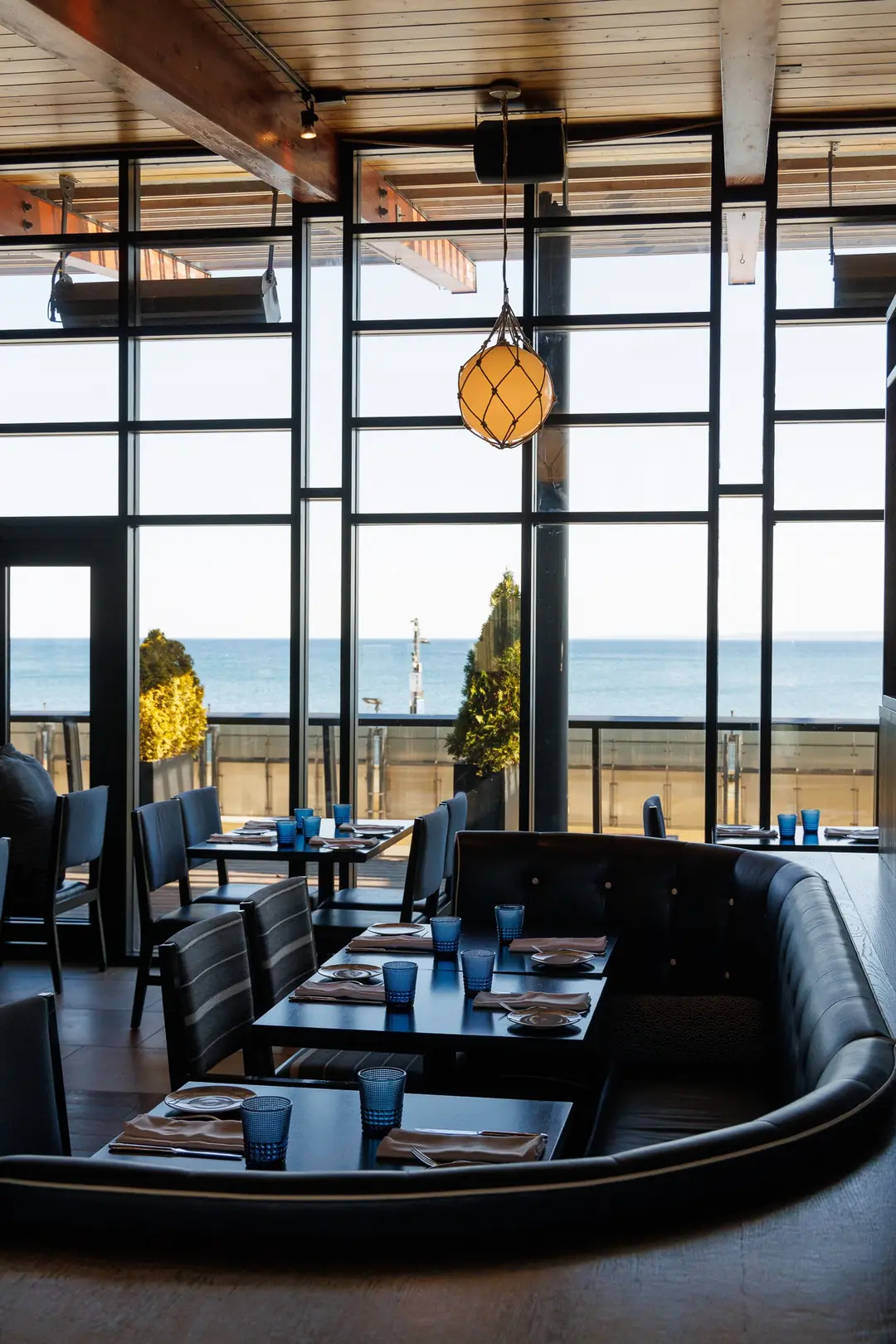 Spencer’s glass-walled dining room looking straight out onto Lake Ontario